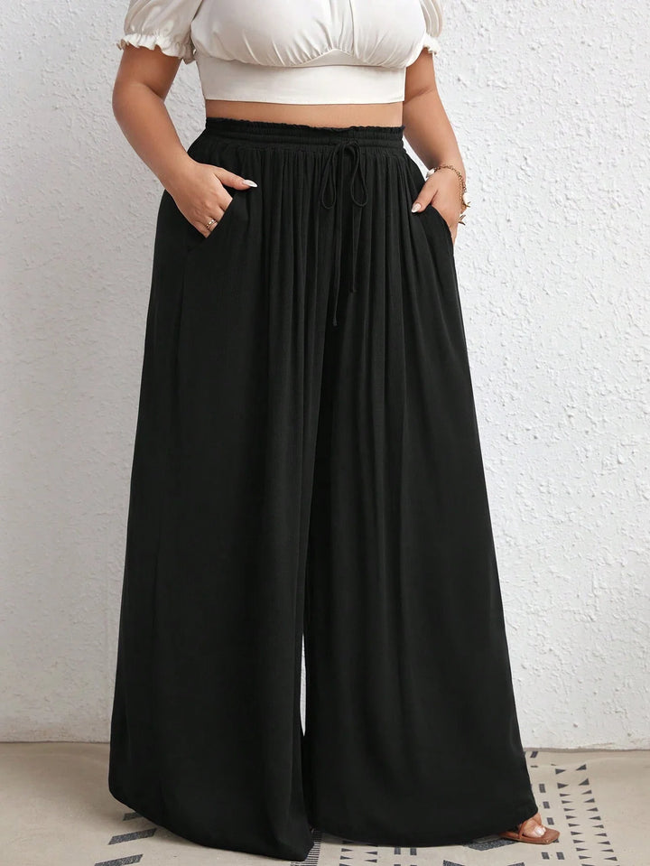 Pantalones de tiro alto con pierna ancha, con cintura en la cintura, bolsillos laterales, en tejido de canalé